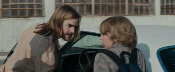 Movie still from “Super 8” (2011), directed by J.J. Abrams – Two young boys are talking in a car; Medium shot, Over the shoulder angle