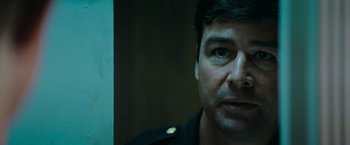 Movie still from “Super 8” (2011), directed by J.J. Abrams – A man's face in front of a mirror; Close Up shot, Over the shoulder angle