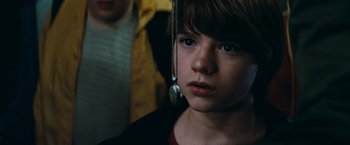 Movie still from “Super 8” (2011), directed by J.J. Abrams – A young boy wearing a pair of ear phones; Close Up shot, Over the shoulder angle