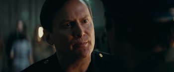 Movie still from “Super 8” (2011), directed by J.J. Abrams – A person wearing a black uniform; Close Up shot, Over the shoulder angle