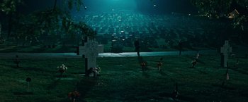 Movie still from “Super 8” (2011), directed by J.J. Abrams – A person standing in front of a cemetery at night; Extreme Wide shot, High angle