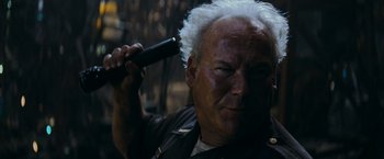 Movie still from “Super 8” (2011), directed by J.J. Abrams – An older man with a white hair holding a hair trimmer in front of his face; Close Up shot, Low angle