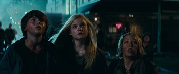 Movie still from “Super 8” (2011), directed by J.J. Abrams – A woman with long blonde hair standing next to another woman; Medium shot, Low angle