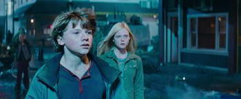 Movie still from “Super 8” (2011), directed by J.J. Abrams – A boy and a girl are standing in a dark room; Medium shot, Low angle