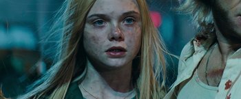 Movie still from “Super 8” (2011), directed by J.J. Abrams – A person with long blonde hair; Close Up shot, Low angle