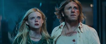 Movie still from “Super 8” (2011), directed by J.J. Abrams – A man and a woman standing next to each other; Close Up shot, Low angle