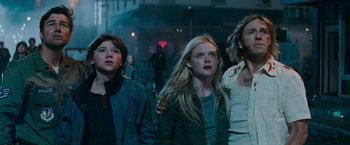 Movie still from “Super 8” (2011), directed by J.J. Abrams – A group of people standing next to each other on a street; Medium shot, Low angle