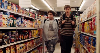 Movie still from “Superbad” (2007), directed by Greg Mottola – Two young men are walking in a grocery store; Medium shot, Over the shoulder angle