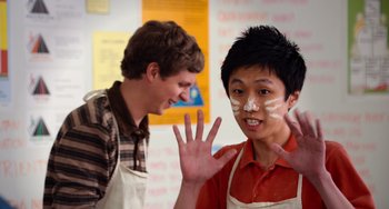 Movie still from “Superbad” (2007), directed by Greg Mottola – Two young men are posing for a picture; Medium shot, Over the shoulder angle