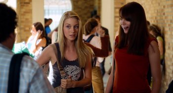 Movie still from “Superbad” (2007), directed by Greg Mottola – Two young women standing next to each other in a building; Medium shot, Over the shoulder angle