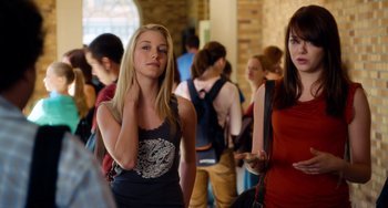 Movie still from “Superbad” (2007), directed by Greg Mottola – Two young women standing next to each other in a crowd; Medium shot, Over the shoulder angle