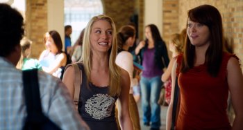 Movie still from “Superbad” (2007), directed by Greg Mottola – A woman standing in front of a group of people; Medium shot, Over the shoulder angle