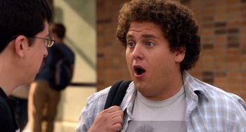 Movie still from “Superbad” (2007), directed by Greg Mottola – A person with a backpack; Close Up shot, Over the shoulder angle