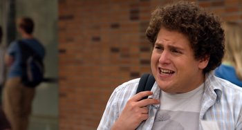 Movie still from “Superbad” (2007), directed by Greg Mottola – A young man holding a cell phone to his ear; Close Up shot, Over the shoulder angle