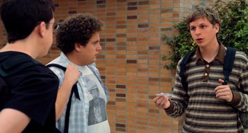 Movie still from “Superbad” (2007), directed by Greg Mottola – Two young men standing next to a brick wall; Medium shot, Over the shoulder angle