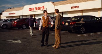 Movie still from “Superbad” (2007), directed by Greg Mottola – Two young men are talking in a parking lot; Wide shot, Over the shoulder angle