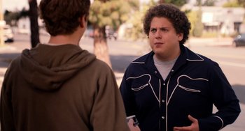 Movie still from “Superbad” (2007), directed by Greg Mottola – Two men are standing outside talking to each other; Medium shot, Over the shoulder angle