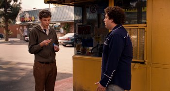 Movie still from “Superbad” (2007), directed by Greg Mottola – Two men standing on the side of the road talking; Medium shot, Over the shoulder angle