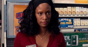 Movie still from “Superbad” (2007), directed by Greg Mottola – A woman in a red shirt and a black headband; Close Up shot, Over the shoulder angle