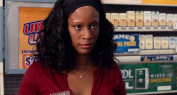 Movie still from “Superbad” (2007), directed by Greg Mottola – A woman in a red shirt and black head band; Close Up shot, Over the shoulder angle