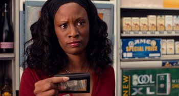 Movie still from “Superbad” (2007), directed by Greg Mottola – A woman holding a cell phone in her hand; Close Up shot, Over the shoulder angle