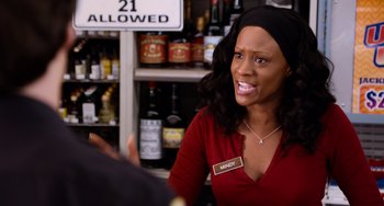 Movie still from “Superbad” (2007), directed by Greg Mottola – A woman in a red shirt is sitting at a counter; Close Up shot, Over the shoulder angle