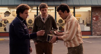 Movie still from “Superbad” (2007), directed by Greg Mottola – A group of young men standing next to each other on a street; Medium shot, Over the shoulder angle
