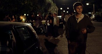 Movie still from “Superbad” (2007), directed by Greg Mottola – A group of people standing on the side of a road; Medium shot, Over the shoulder angle