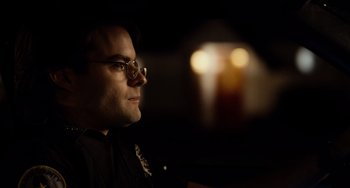 Movie still from “Superbad” (2007), directed by Greg Mottola – A man wearing glasses looking to his left; Close Up shot, Over the shoulder angle