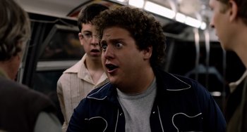 Movie still from “Superbad” (2007), directed by Greg Mottola – Two young men standing next to each other on a train; Close Up shot, Low angle