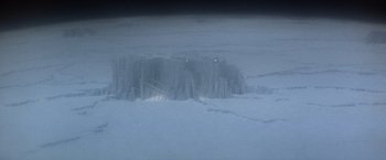 Movie still from “Superman” (1978), directed by Richard Donner – A view from a plane looking at a mountain; Extreme Wide shot, Overhead angle