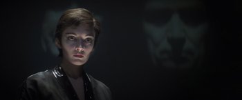 Movie still from “Superman” (1978), directed by Richard Donner – A woman with short brown hair is looking at the camera; Close Up shot, Low angle