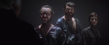 Movie still from “Superman” (1978), directed by Richard Donner – A man with a beard is standing next to another man with a beard; Medium shot, Low angle