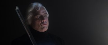 Movie still from “Superman” (1978), directed by Richard Donner – An older man with white hair and a black shirt; Close Up shot, Low angle