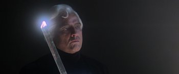 Movie still from “Superman” (1978), directed by Richard Donner – A person holding a sword; Close Up shot, Low angle