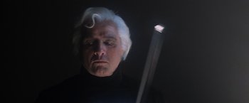 Movie still from “Superman” (1978), directed by Richard Donner – A man with a white hair and a white beard is looking at a light; Close Up shot, Low angle