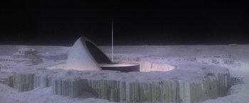 Movie still from “Superman” (1978), directed by Richard Donner – An image of an image of a building in the middle of the night; Extreme Wide shot, High angle