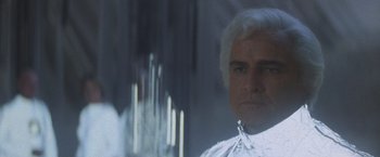 Movie still from “Superman” (1978), directed by Richard Donner – A person wearing a white wig; Close Up shot, Low angle