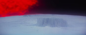Movie still from “Superman” (1978), directed by Richard Donner – A view of a red sky from a plane window; Extreme Wide shot, Low angle