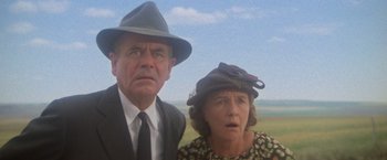 Movie still from “Superman” (1978), directed by Richard Donner – An older man and a younger woman standing next to each other; Close Up shot, Low angle