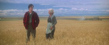 Movie still from “Superman” (1978), directed by Richard Donner – A man and a woman standing in a wheat field; Wide shot, Low angle