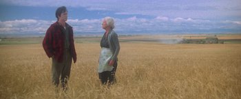 Movie still from “Superman” (1978), directed by Richard Donner – Two people standing in a wheat field looking at each other; Wide shot, Low angle