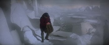 Movie still from “Superman” (1978), directed by Richard Donner – A person standing in the middle of an icy lake; Wide shot, High angle