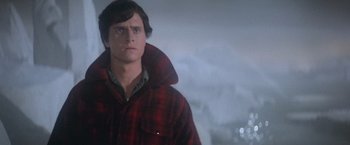Movie still from “Superman” (1978), directed by Richard Donner – A man in a red plaid jacket looking at the camera; Close Up shot, Low angle
