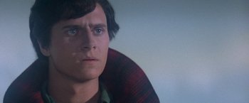 Movie still from “Superman” (1978), directed by Richard Donner – A person wearing a plaid shirt; Close Up shot, Over the shoulder angle