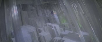 Movie still from “Superman” (1978), directed by Richard Donner – A person standing on top of a pile of rocks; Extreme Wide shot, High angle