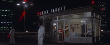 Movie still from “Superman” (1978), directed by Richard Donner – People are standing in front of a building; Wide shot, Low angle