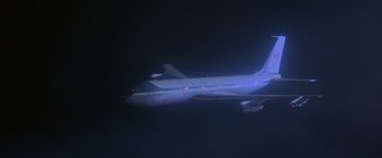 Movie still from “Superman” (1978), directed by Richard Donner – An airplane flying through the night sky at night; Extreme Wide shot, Low angle