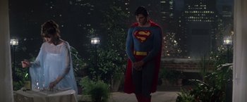 Movie still from “Superman” (1978), directed by Richard Donner – A man dressed as superman standing in front of a building; Medium shot, Over the shoulder angle