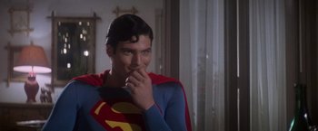 Movie still from “Superman” (1978), directed by Richard Donner – A man in a superman costume holding his hand to his face; Close Up shot, Over the shoulder angle